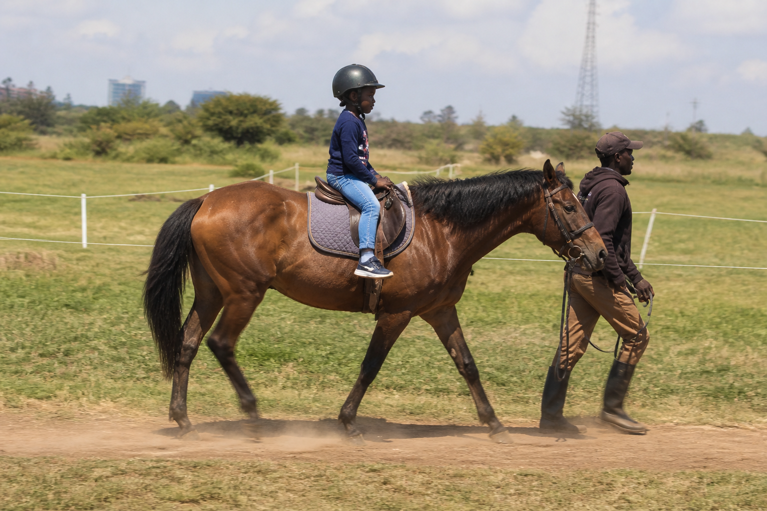 horse riding experience hire Nairobi child riding horse with handler outdoor field