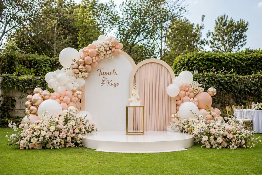Elegant wedding balloon backdrop with stage in Nairobi garden