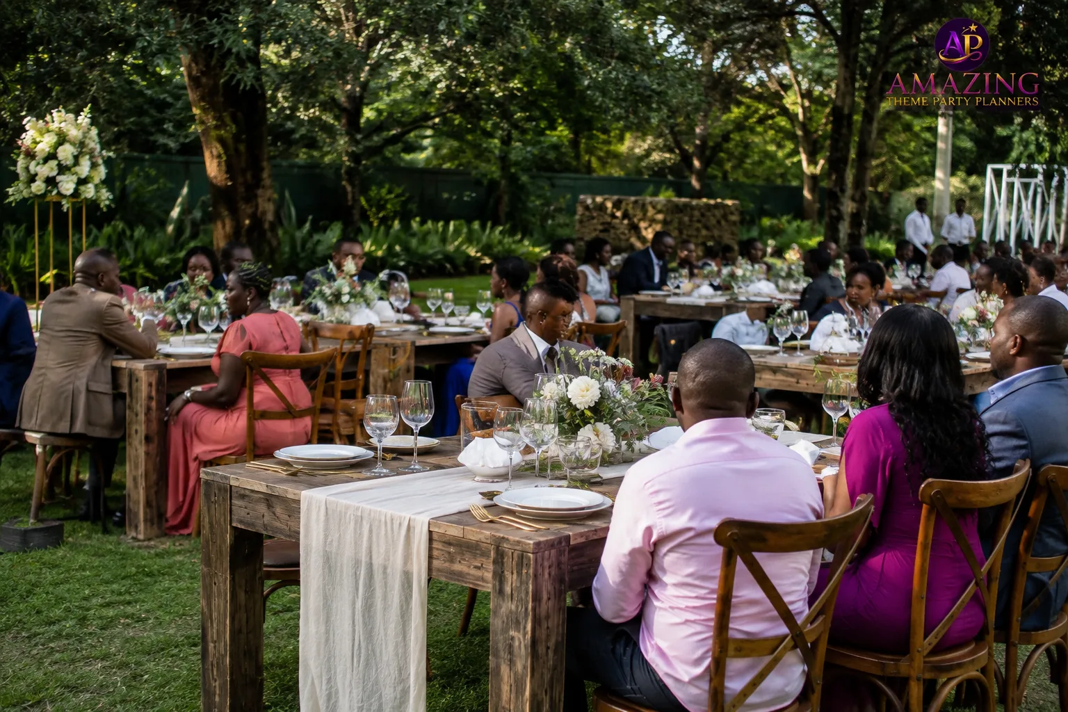 Vintage rustic tables dressed for an elegant outdoor wedding reception in Nairobi with natural wooden finishes 