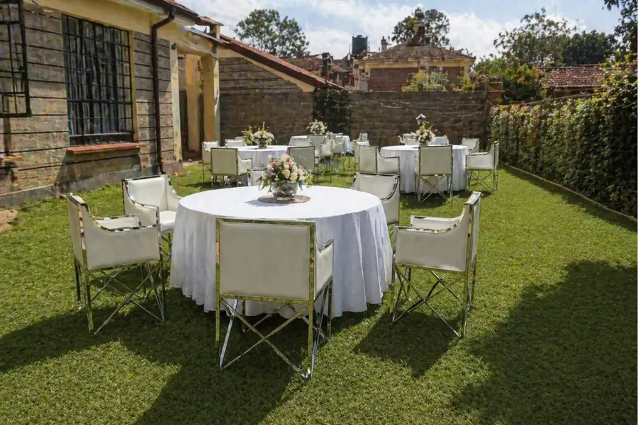 White and silver seats arranged in a Nairobi residential backyard party setup